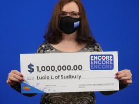 Lucie Lessard of Sudbury picks up her $1 million Encore prize. OLG photo
