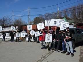 Local Teamsters gathered outside of the Kenora railway station in front of a stopped CP Rail train. Photo by Bronson Carver