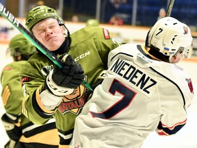 The North Bay Battalion's Ty Nelson collides with Kevin Niedenz of the visiting Barrie Colts in the Troops' 3-2 Ontario Hockey League win Sunday. Nelson was with Team Red in the Canadian Hockey League-National Hockey League Top Prospects Game at Kitchener on Wednesday night.
Sean Ryan Photo