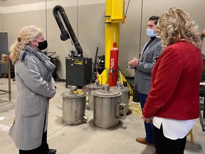 Sudbury MP Viviane Lapointe tours an EV development facility at Cambrian with Mike Commito, director of applied research at the college, and Kristine Morrissey, VP of international, finance and administration.