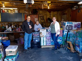 Rob and Cathy Bennington along with daughter Alison Brown in the Bennington garage with supplies gathered for Ukraine from the High River community.