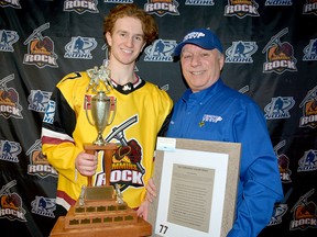 The Ray “Thibaudeau” Auclair Trophy is awarded annually to the Timmins Rock’s Most Spirited Player, a mucker, grinder and digger. This year’s winner, forward Nicholas Frederick, accepts the trophy and a plaque from Auclair, the Rock super fan who had it created. Frederick joins previous recipients Wayne Mathieu (2018), Linder Spencer (2019), Eric Moreau (2020) and Derek Seguin (2021) as Rock players who have been honoured. THOMAS PERRY/THE DAILY PRESS
