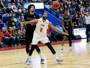 Sudbury Five centre Evan Harris (0) battles for position with Tyran Walker (7) of the KW Titans during NBLC action at Sudbury Community Arena in Sudbury, Ontario on Saturday, March 26, 2022.