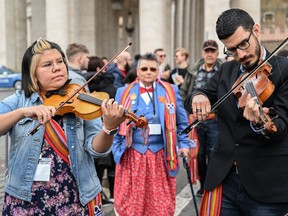 Alex Kusturok, from Cold Lake (right) plays the fiddle as part of Canada's Indigenous People's delegations in The Vatican on March 28, 2022 at St. Peter's square. (Photo by Andreas SOLARO / AFP)