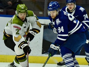 Nikita Tarasevich of the visiting North Bay Battalion vies for the puck with Aidan Prueter of the Mississauga Steelheads in Ontario Hockey League action Sunday. The Troops won 2-1 to pad their Central Division lead.
Sean Ryan Photo