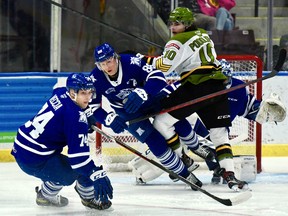 Michael Podolioukh of the North Bay Battalion collides with Ole Bjorgvik-Holm of the host Mississauga Steelheads in front of goaltender Roman Basran in Ontario Hockey League action Sunday. Zander Vecci is also on the scene.
Sean Ryan Photo