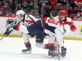 Soo Greyhounds defenceman Robert Calisti (right) gets turned around while attempting to skate between two Windsor Spitfires defenders during the first period of Sunday afternoon OHL play at GFL Memorial Gardens. Gordon Anderson