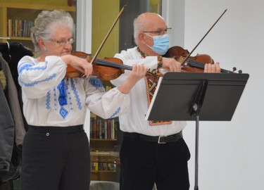 Violinists perform the Ukrainian national anthem during a service on Sunday calling for peace in eastern Europe.