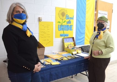 Pam Gilbert, left, and Barbara Smatlanek of the Ukrainian Seniors Centre sell flags, scarves, masks and sunflower seeds to raise funds for those impacted by the war.