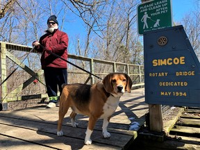 To pave or not to pave?: That is the question rail enthusiasts in Norfolk County are discussing following word of an ambitious proposal to pave 11 kilometres of the Heritage Trail in Waterford north to the Brant County line. Checking out the Lynn Valley Trail in Simcoe Tuesday was Mike Bonaccorso of Simcoe and his beagle Boomer. – Monte Sonnenberg