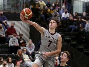 Frontenac Falcons' Chad Cybulski goes for a layup over La Salle Black Knights' Aidan Homer during the Kingston Area Secondary Schools Athletic Association senior boys basketball championship game at St. Lawrence College on Tuesday night.