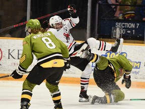 Ty Nelson of the host North Bay Battalion collides with Pano Fimis of the Niagara IceDogs in their Ontario Hockey League game Thursday night as Avery Winslow stays close to the action. The Battalion entertains the Barrie Colts on Sunday.
Sean Ryan Photo