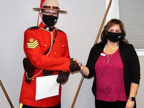 Staff Sgt. Grant Kneller shook hands with town Coun. Becky Wells. The Mayerthorpe RCMP recently consulted town residents on local policing.