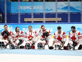Silver medal winners Team Canada, including captain Tyler McGregor, far right, react during the para hockey medal ceremony after the gold-medal game at the Beijing 2022 Winter Paralympics at the National Indoor Stadium on March 13, 2022 in Beijing, China. (Ryan Pierse/Getty Images)