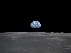 This photo obtained from NASA and taken by the Apollo 11 crew shows an Earthrise viewed from lunar orbit prior to landing on July 20, 1969. - When the Saturn V rocket built by Wernher von Braun launched with the Apollo 11 capsule at its summit on July 16 1969, one million people flocked to watch the spectacle on the beaches of Florida near Cape Canaveral. But many had doubts that they'd succeed in landing this time. /AFP/Getty Images