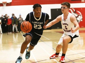 Ursuline Lancers' Caleb Roberts, left, is guarded by Northern Vikings' Conor Jones during the LKSSAA 'AAA' senior boys' basketball final at Northern Collegiate in Sarnia, Ont., on Tuesday, March 8, 2022. Mark Malone/Chatham Daily News/Postmedia Network
