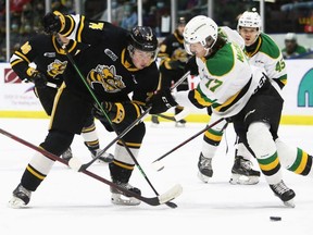 Sarnia Sting's Ethan Ritchie (74) tries to get past London Knights' Ethan MacKinnon (17) in the first period at Progressive Auto Sales Arena in Sarnia, Ont., on Sunday, March 13, 2022. Mark Malone/Chatham Daily News/Postmedia Network