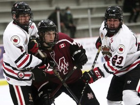 Chatham Maroons' Matthew Cunningham, centre, is sandwiched by Sarnia Legionnaires' Jake MacLean, left, and Cameron Lightfoot at Chatham Memorial Arena in Chatham, Ont., on Saturday, March 19, 2022. Mark Malone/Chatham Daily News/Postmedia Network
