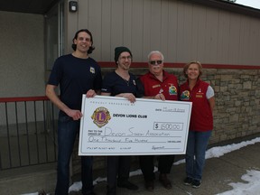 Mikaul Maygard (left) and Sam Ruediger of the Devon Soccer Association received a $1,500 cheque from Lyle Gustafson and Diane Ruediger of the Devon Lions Club. (Ted Murphy)