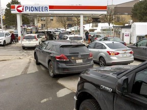 Motorists line up for gas at a Pioneer station on Commissioners Road West on Wednesday.  The price of regular gasoline in London, about $1.60 a liter Wednesday, was expected to jump to $1.67 Thursday.  (Mike Hensen/The London Free Press)