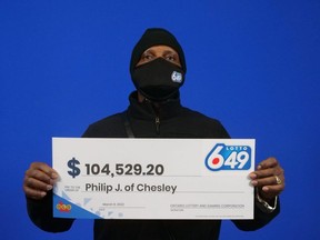 Philip Jackman of Chesley with the winner's cheque at the OLG Prize Centre in Toronto.