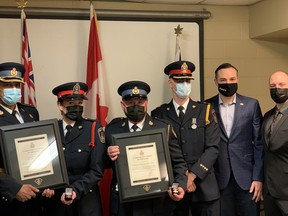 Brantford Police Det. Christine McCallum, second from left, and her husband, Burlington OPP Const. James Gallant, were honoured last week with an OPP Commissioner's Citation and life-saving pins by OPP Superintendent Andre Phelps, left, Brantford Police Deputy Chief Jason Saunders, Police Association of Ontario president Mark Baxter and Brantford Police Association president Jeremy Morton.