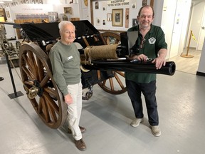 Don Wilkin, left, and Don Musson, both on the board of the Canadian Military Heritage Museum, show off the facility's newest large donation – a fully restored 1906 British cannon “18-pounder”. The museum is open every afternoon this week.