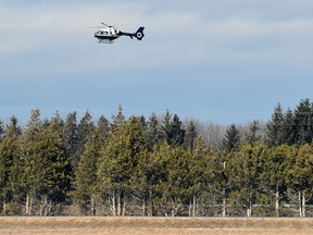 A low-flying Huron search rescue helicopter is visible just east of Mitchell Sunday afternoon, March 6, as fire departments search the tributaries of Whirl Creek after reports of a child fell through ice around 10:30 a.m. ANDY BADER/MITCHELL ADVOCATE