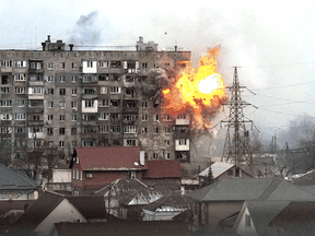An explosion is seen in an apartment building after Russian's army tank fires in Mariupol, Ukraine, March 11, 2022.