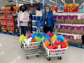 Juni, co-manager of the Leduc Walmart, presents baskets of treats to Colleen Zimmerman, executive director of the Leduc Community Hospital Foundation. (Leduc Community Hospital Foundation)