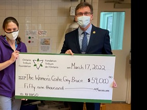 The Women's Centre Grey Bruce received a $59,000 Resilient Communities Fund grant, awarded by the Ontario Trillium Foundation (OTF) in 2021, to help continue serving women in the community. From left to right, board member Alissa Angel, cook Allison Hillyer, and MPP Bill Walker. Photo submitted