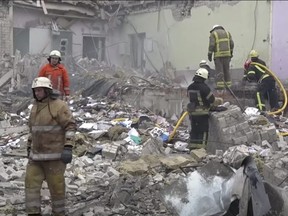 Workers clear debris of a school building destroyed by shelling, as Russia's invasion of Ukraine continues, in Zhytomyr, Ukraine March 4, 2022 in this still image obtained from a handout video. Ukraine National Police/Handout via REUTERS    THIS IMAGE HAS BEEN SUPPLIED BY A THIRD PARTY NO RESALES. NO ARCHIVES MANDATORY CREDIT