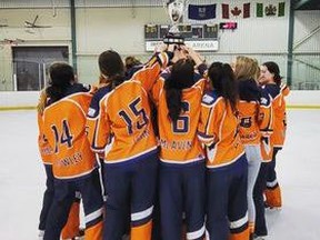 The Zone 2 U16AA ringette team triumphantly lift their hard-earned trophy over the ice after being declared provincial champions on February 27. The team will be representing the province when nationals happens in Calgary starting April 3. Photo courtesy of Jenn Rice