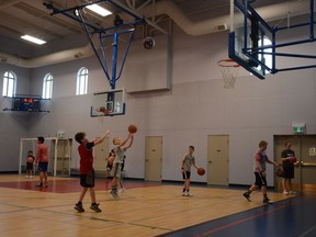 Airdri kids take some practice shots while warming up for the first FCBA Blizzards camp in Airdrie on March 26. Photo by Riley Cassidy/The Airdrie Echo/Postmedia Network Inc.