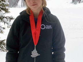 Mitchell's Lilly Bender is pictured with her silver medal with the Rocky Mountains in the background after her synchronized skating team, Team Unity based in Tavistock, finished second at the national championships in Calgary Feb. 26-27.