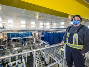 Ben Brant, a water operator at the Mohawks of the Bay of Quinte Water Treatment Plant, stands above the many pipes, filters and tanks used in cleaning the regions water. Tuesday in Tyendinaga, Ontario. ALEX FILIPE