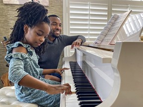 Seven-year-old Ayva Roach of Brantford practises for her performance in the upcoming Brant Music Festival, with the assistance of her father Max Roach.