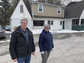 Brant County Coun. John MacAlpine and Gwen Hunter stand in front of the former SuperTest Petroleum Station in St. George. Brant County councillors on Tuesday recommended demolition of the building to expand an  adjacent parking lot.