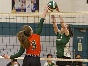 A spike by Morgan Hunt (left) of North Park Collegiate is blocked by Anna Carter of St. John's College during a high school senior girls volleyball game on Tuesday.