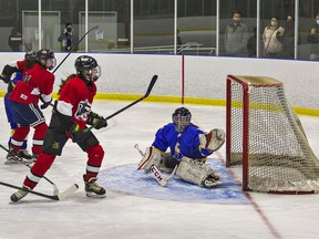 Madison Burr of the Paris Panthers watches her shot beat BCI Mustangs goalie Kahs Green in the high school girls hockey final on Wednesday March 2, 2022 at the Wayne Gretzky Sports Centre in Brantford, Ontario. Paris defeated BCI 4-2.