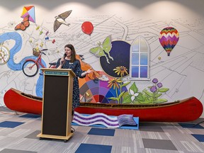 Rae-Lynne Aramburo, chief librarian and CEO of the Brantford Public Library stands in front of a mural in the re-imagined child and youth space that was unveiled on Monday.