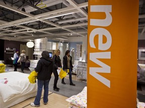 Shoppers check out displays at an Ikea store. Postmedia