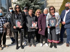 Family members hold pictures of Melissa Miller, Alan Porter and Michael Jamieson on Thursday outside Superior Court in Brantford where a sentencing hearing was held for two people charged in deaths of their loved ones.  Susan Gamble