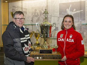 Rick Mannen, chair of the Frank Tomlin Award selection committee, presents the trophy for sportsperson of the year to Brantford's Erika Polidori.