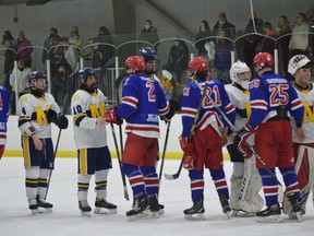 Morrisburg (white jerseys) and South Grenville players line up at the end of their five-game playoff series Wednesday night. The Lions led 2-1, but the Jr. C Rangers evened the series and won the deciding game on home ice in Cardinal on Wednesday night. South Grenville and North Dundas will meet in the next round.
Tim Ruhnke/The Recorder and Times