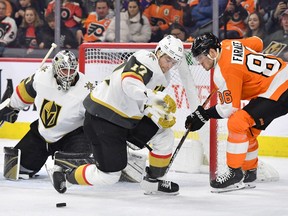 Vegas defenceman Ben Hutton and Flyers winger Joel Farabee battle for the puck in front of Golden Knights goaltender Robin Lehner 
Eric Hartline/USA TODAY Sports
