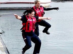 Constable Dana Darlington and Acting Sergeant Lynsay Dickson of the Gananoque Police Service jump into the St. Lawrence River on Monday for the Polar Plunge in support of Special Olympics Ontario. (SUBMITTED PHOTO)