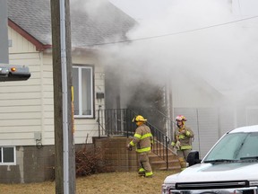 Smoke pours from a house that caught on fire on Inshes Avenue in Chatham on Monday. (Ellwood Shreve/Chatham Daily News)