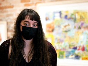 Chatham artist Michaela Lucio is shown in front of one of the pieces from her exhibition, A Small Good Thing, at ARTspace in downtown Chatham March 9, 2022. The show is on display until March 26.