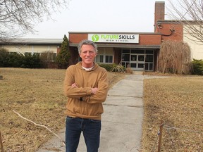 Chatham Coun. Michael Bondy stands in front of the former Victoria Park public school building that will become the location of a new, temporary emergency shelter for homeless people. (File photo)